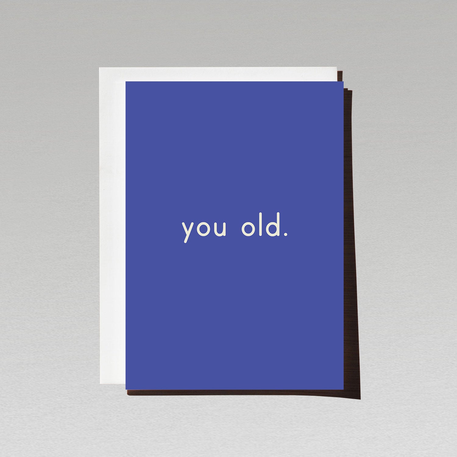 Birthday card with minimalist white text you old. on blue background